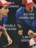 Book cover for Ericka Beckman: Double Reverse featuring a photograph of two men huddled in a circle wearing baseball caps. The exhibition title is shown reflected twice on the cover.