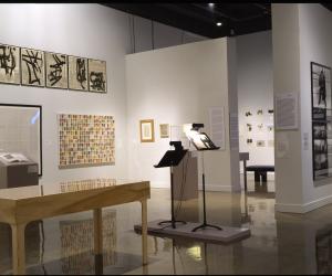 Artwork in various mediums and styles are spaced throughout the gallery on the walls, on stands, and in cases.