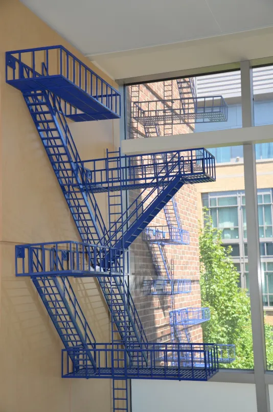 Blue sculpture created out of multiple ladder forms