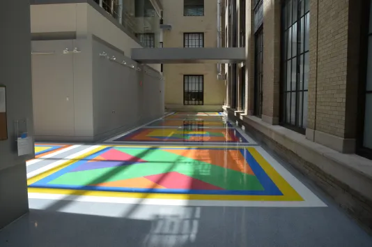 Sol Lewitt's colorful Terrazzo floor Illuminated by light and shadows.