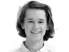 A black and white head shot of a student guide smiling at the camera.