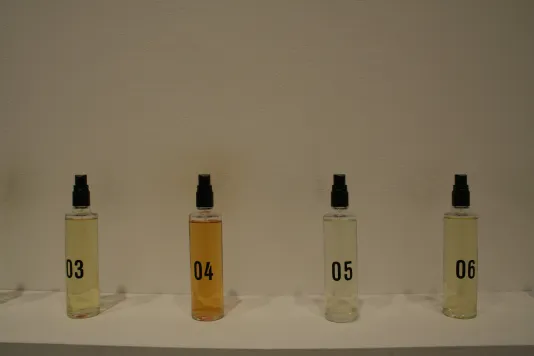 Image of four perfume spray bottles marked with numbers.