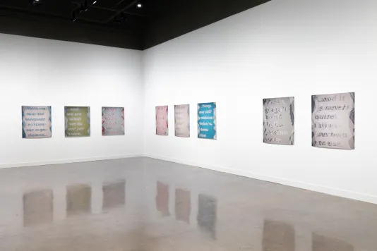Installation view featuring three colored inkjet prints on vinyl on the left wall and five on the right wall.