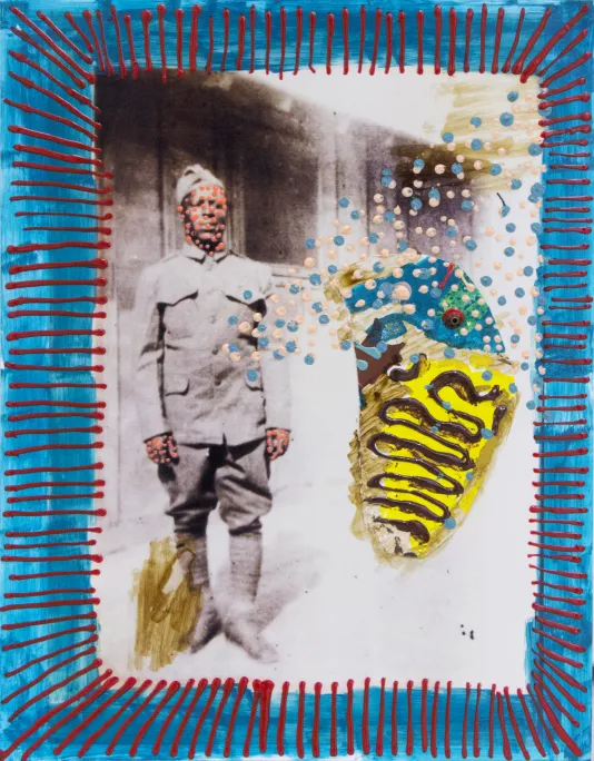 Photograph of a man in uniform with dots of pink paint covering his face and a thick blue border with red stripes around the edge.