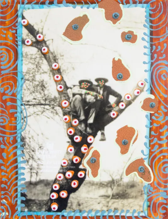 Black and white low resolution photograph of two people sitting in a tree. The artist painted over their faces with small dots and added a pattern on the tree bark and border of the photograph.