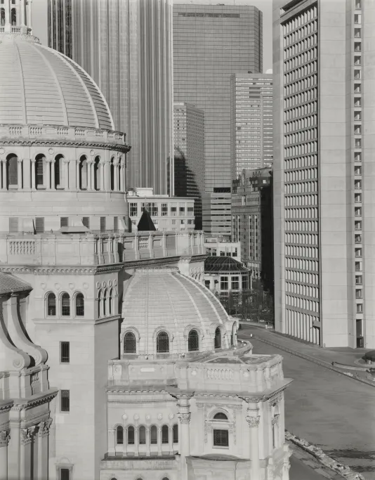 Black and white photograph of the Christian Science Center in Boston surrounded by other large scale buildings.