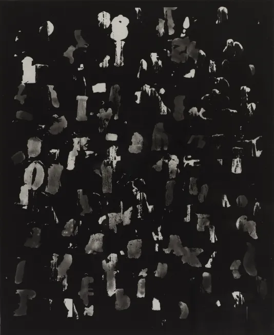 Black and white photograph of a crowded group of people taking up the entire frame.