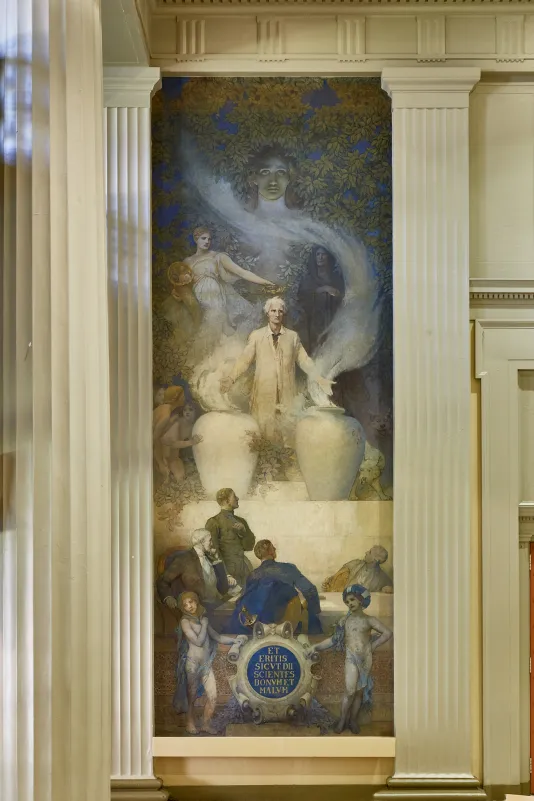 Vertical, large-scale mural hung in a conference room. 