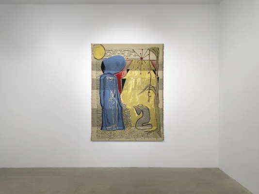 A gold colored tapestry hangs on a white wall. The left side of the tapestry is occupied by a vertical blue form that resembles a figure, draped in flowing cloth. On the right of the blue figure is the cartoon-like outline of another figure, kneeling in its direction. They are surrounded by abstracted yet recognizable forms: a sun overhead, climbing leaves and vines, rays of energy that recall physics diagrams.