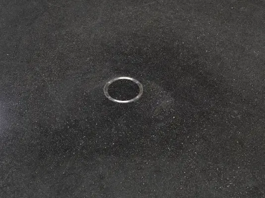 A small metal ring is cemented into the floor.