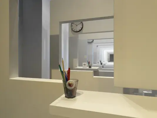 A series of white walls with a window cutout that has a view of the next white wall with a window cutout. There is a cup with office supplies on the window ledge of each wall.