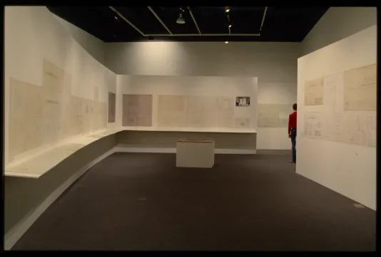 Gallery walls display architectural designs of artist Alvaro Siza. Small landscape models are shown on pedestals.