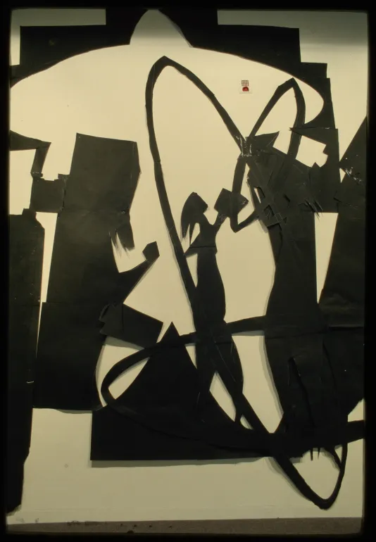 Large black paper cut out hangs on gallery wall depicting scene with abstract human shapes.