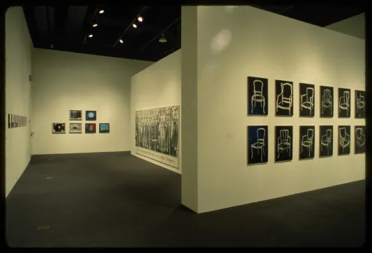 Photographs of all different subjects and sizes line the gallery walls. Images range from objects to portraits.  