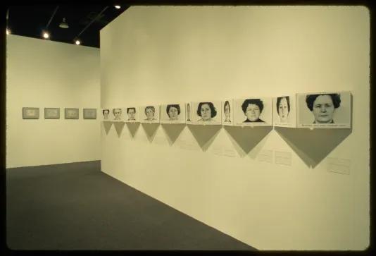 Portraits are installed on the wall in an accordion style. Every other image folds away from the wall to back into the wall. 
