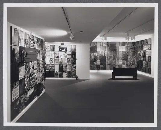 A grid of photographs of historical portraits, documents, and nature images extend across all of the gallery walls. 
