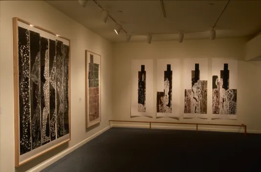 Large, framed and unframed woodblock prints fill the walls in a corner of a small gallery.