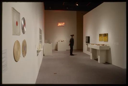 Viewer looking at objects in the gallery distance.