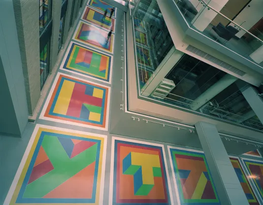 View from above of Sol LeWitt's floor installation including colorful geometric glass and epoxy terrazzo tiles.