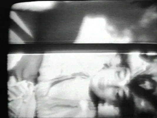 Black and white image of a woman lying on her side. 