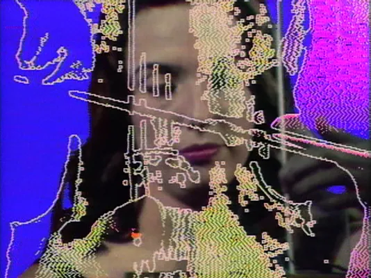 Technicolor glitch still of a woman's face with pixels floating in front of her.
