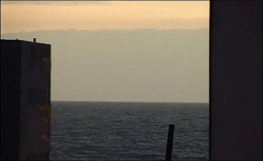Video still of the horizon line of the ocean. 