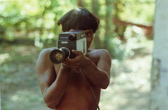 Film Still of a Boy holding a camera pointed at the viewer