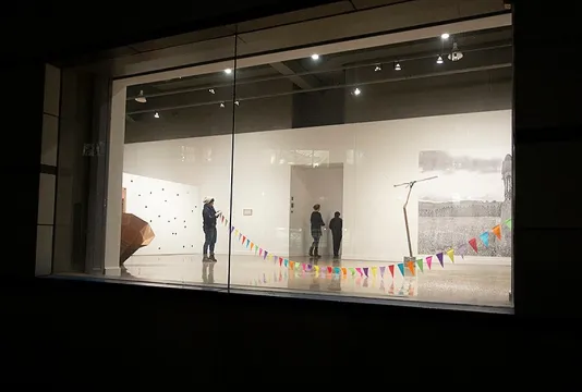 Looking into the List Center's gallery window into Amalia Pica's exhibition.