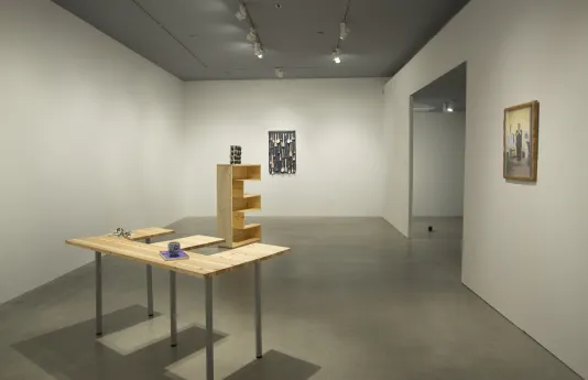 A gallery view of Lina Viste Grønli's exhibition at the List Center features an E-shaped shelf on an E-shaped table.