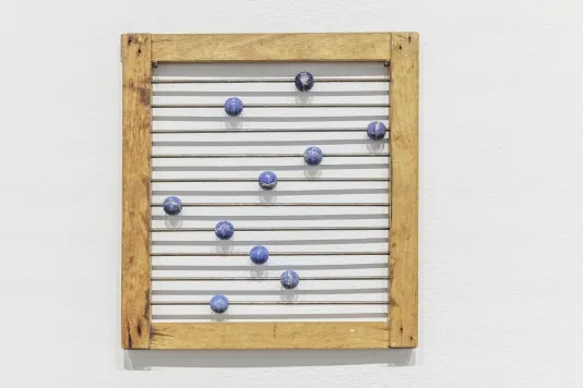 A small abacus with a wooden frame and lapis lazuli beads.