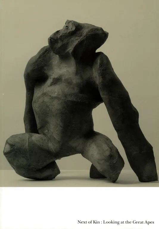 Book cover for Next of Kin: Looking at the Great Apes featuring a stone ape sculpture with a beige background.