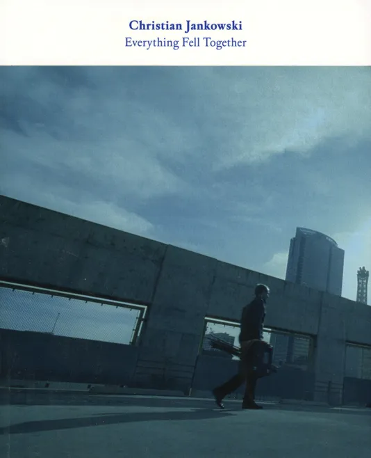 Book cover for Christian Jankowski: Everything Fell Together featuring a photograph of a man walking across a bridge in the city.