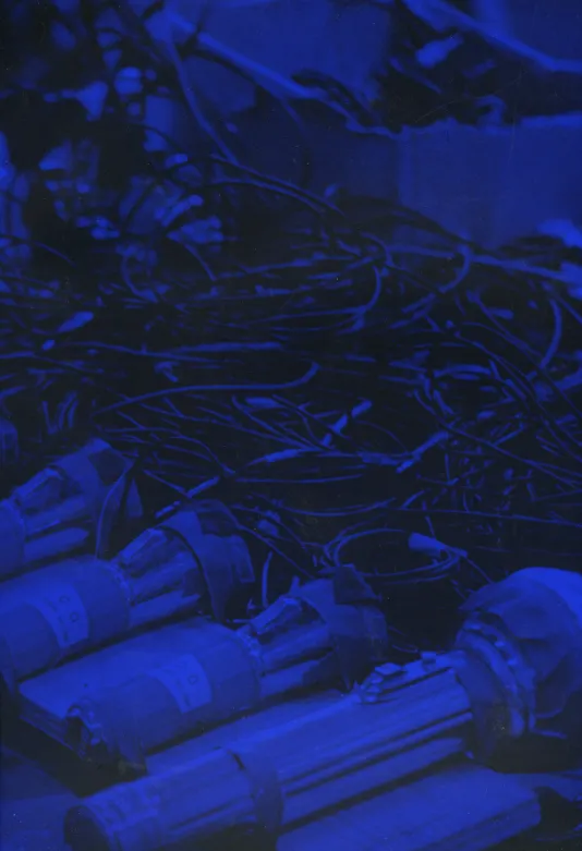 Book cover for 9 Evenings Reconsidered: Art, Theatre, and Engineering, 1966 a blue hued photograph of flashlights and wires.