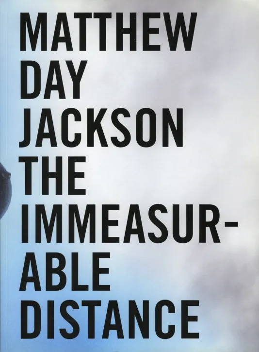 Book cover for Matthew Day Jackson: The Immeasurable Distance featuring a photographic background of a blue sky with smoke and the exhibition title in black bold text.