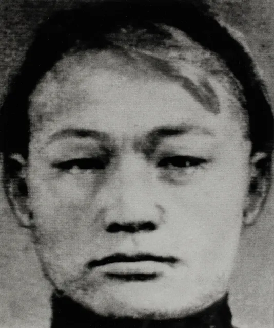 Closeup black and white image of a person's face with a serious look.