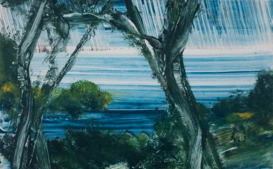 Tropical inlet featuring trees in the foreground and an ocean that fades into the horizon in the background.