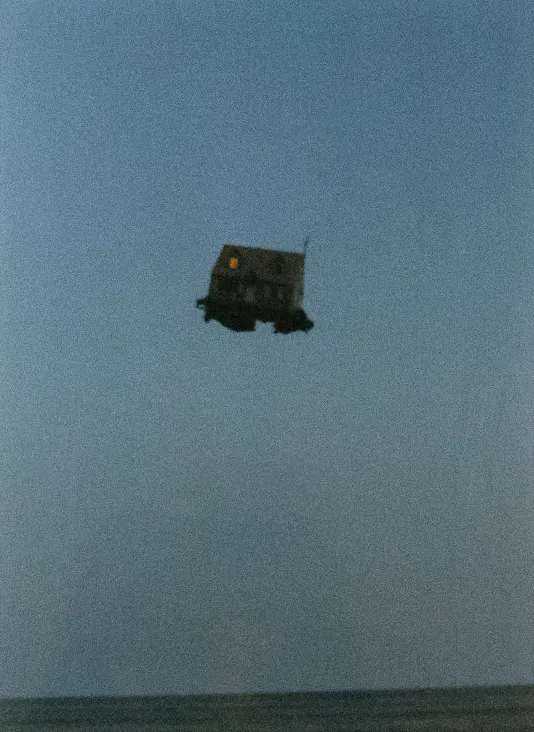 Bluesy with a home floating in the air in the distance.