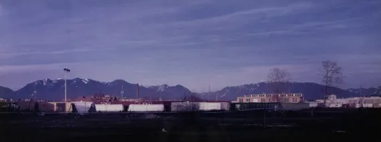 Photograph of a hilly landscape with a blue purple sky fading to dusk.