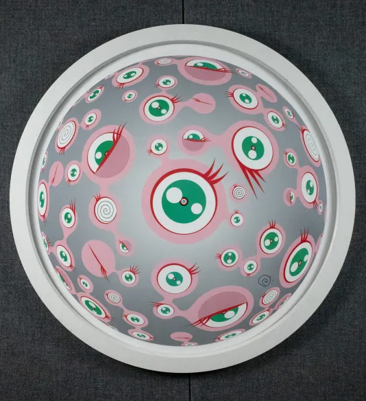 Silver circle with a white edge that has prints of pink circular eye balls within.