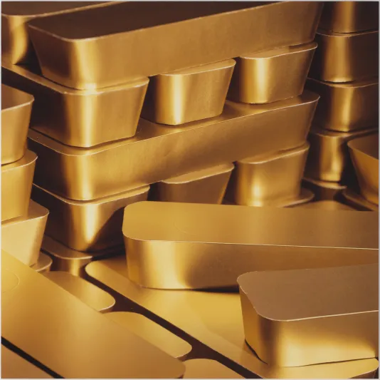 Photographed of gold stacked objects resembling gold bars.
