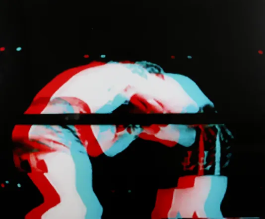 Distorted photograph of two men in a boxing ring with a red and blue overlay that resembles the view with 3d glasses on.
