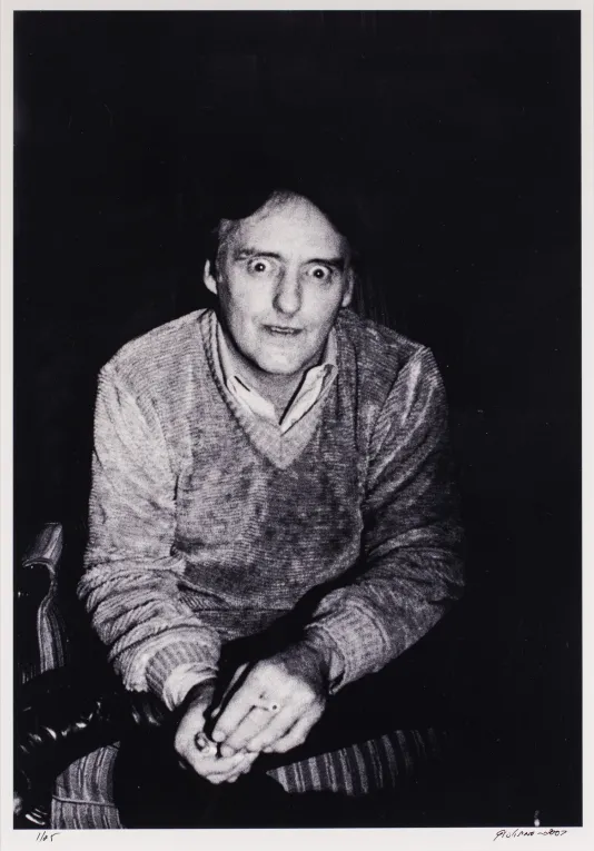 Portrait of Dennis Hopper with his eyes wide and a cigarette in his hands.