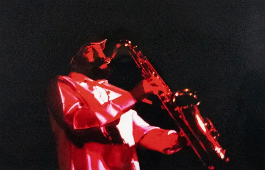 Red print of a man playing the trumpet.
