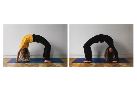 Photograph of two people on yoga mats doing a bridge pose.