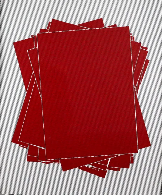 Red rectangular cards with a white border stacked on top of one another with the edges sticking out from previous layers beneath.