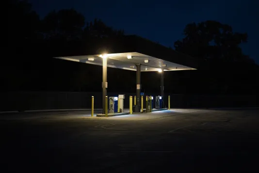 Photograph of a public work station at night lit by the light from the station.