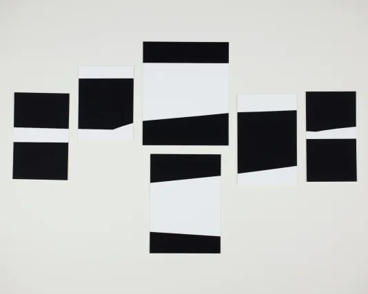 Black and white rectangular shapes placed vertically on the canvas in a line.