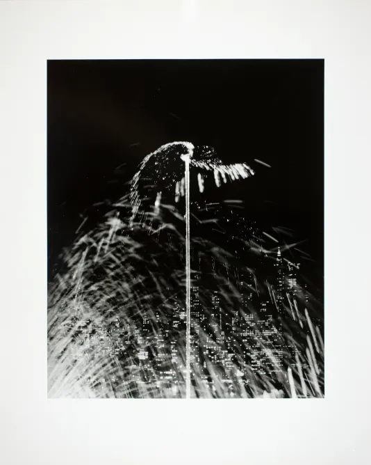Close up black and white photograph of a sprinkler spraying water