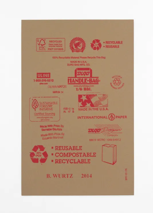 Cardboard with red stamps on it featuring the recycle symbol, a paper bag, and an American flag icon that reads Handmade in the U.S.A.