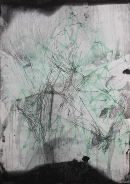 Green and black scribbles on a pieces of faded paper.